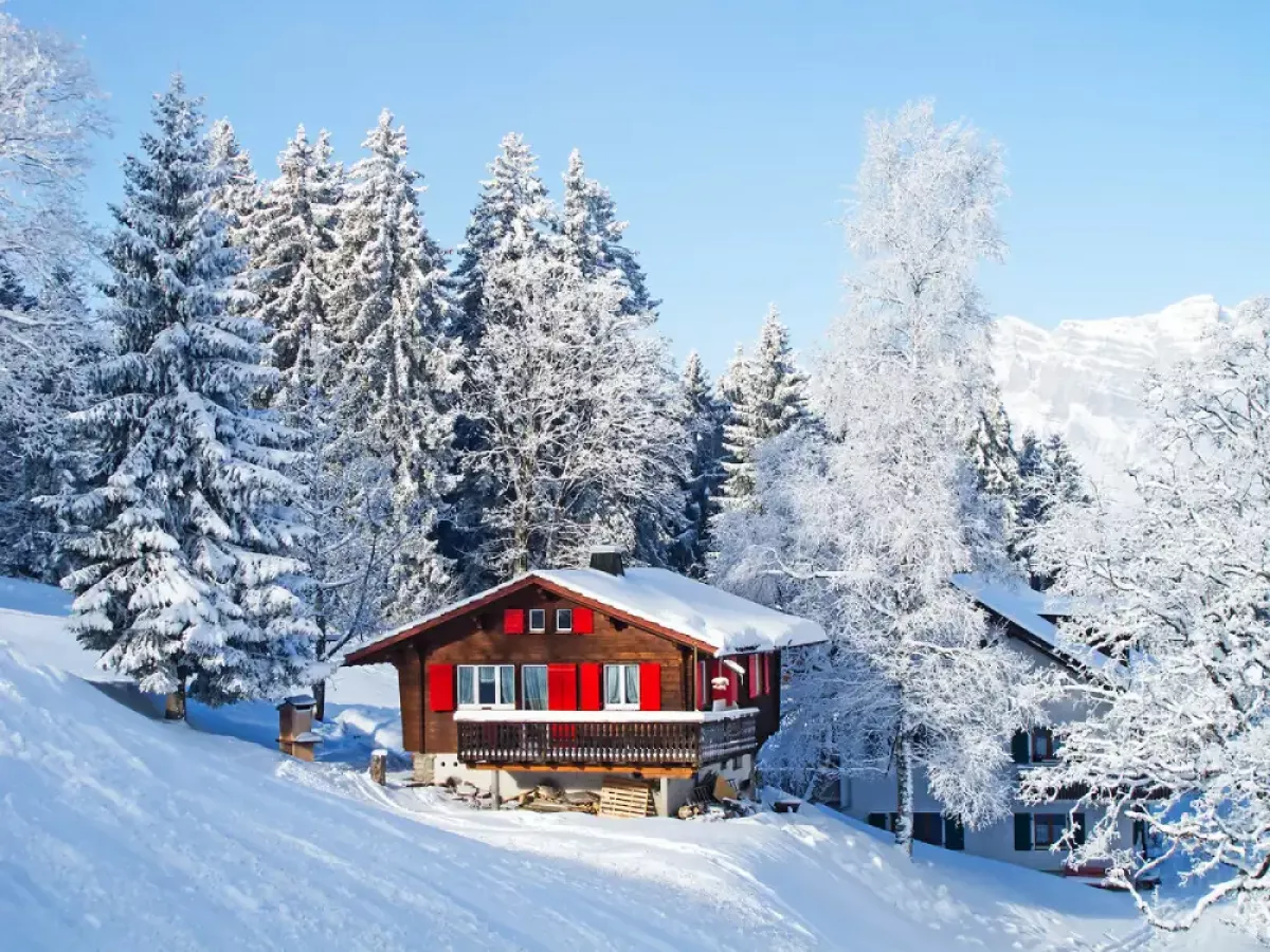 Swiss-chalet-in-winter-covered-in-snow